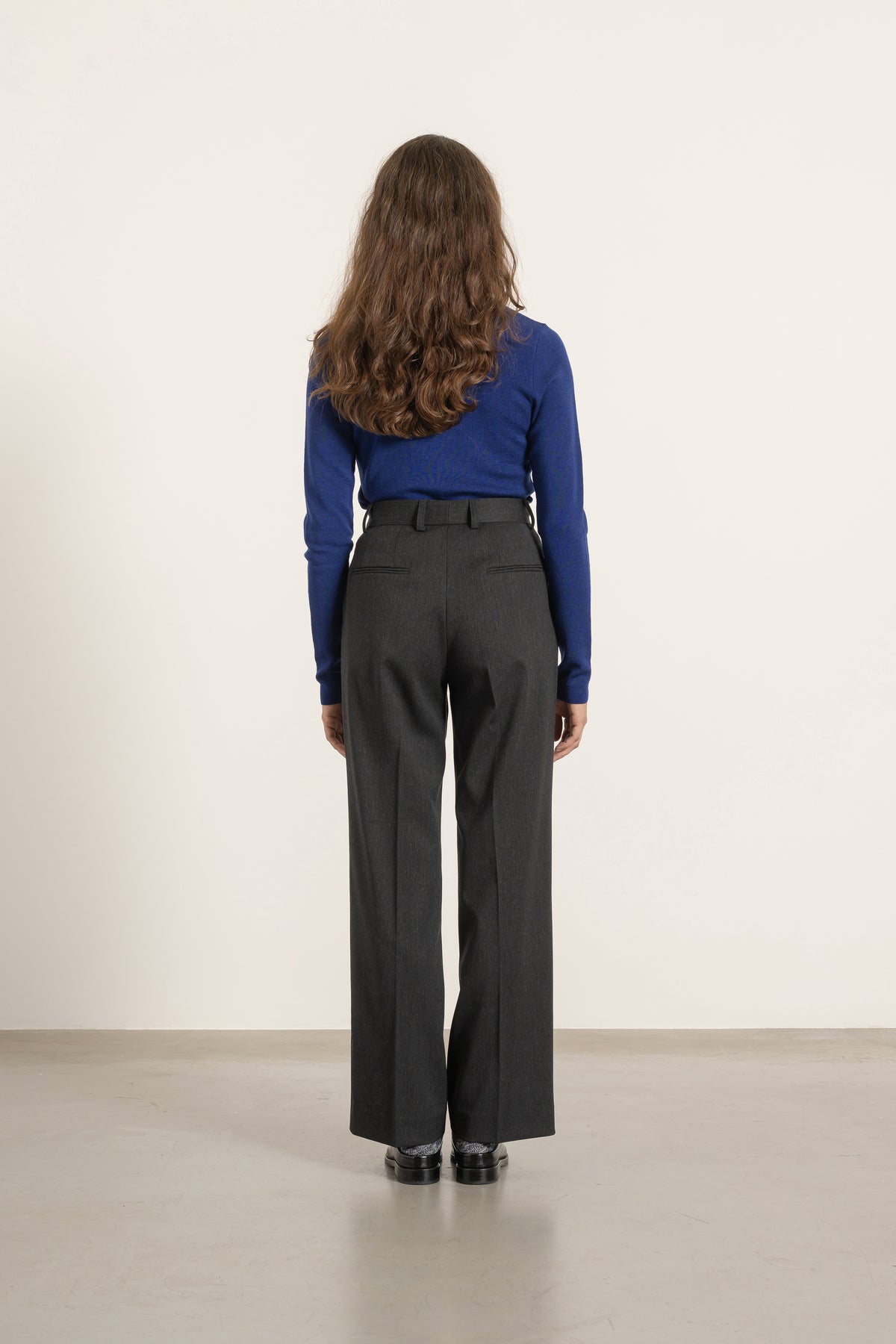 Pantalon Isabelle en laine gris anthracite porté avec Pull Raoul en laine bleu roi, vue de dos | Mardi Editions